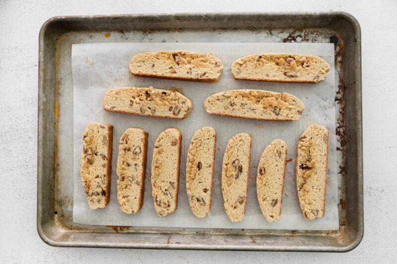 sliced maple pecan biscotti on a baking sheet.