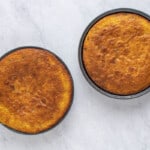 two cakes in a pan on a marble table.