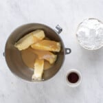 a bowl with butter, sugar and flour on a marble countertop.