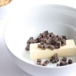 stick of butter and cubes of chocolate in a bowl