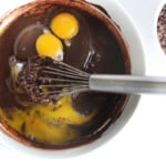mixing eggs into the brownie batter