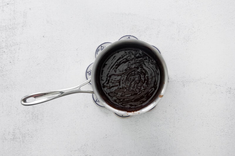 a bowl of chocolate sauce on a white background.