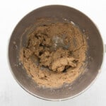 chocolate cookie dough in a mixing bowl on a white background.