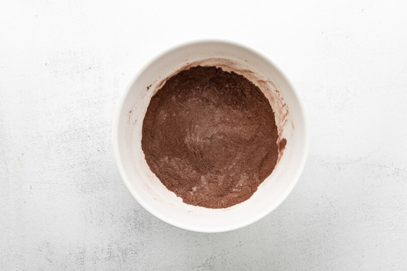 chocolate batter in a bowl on a white surface.