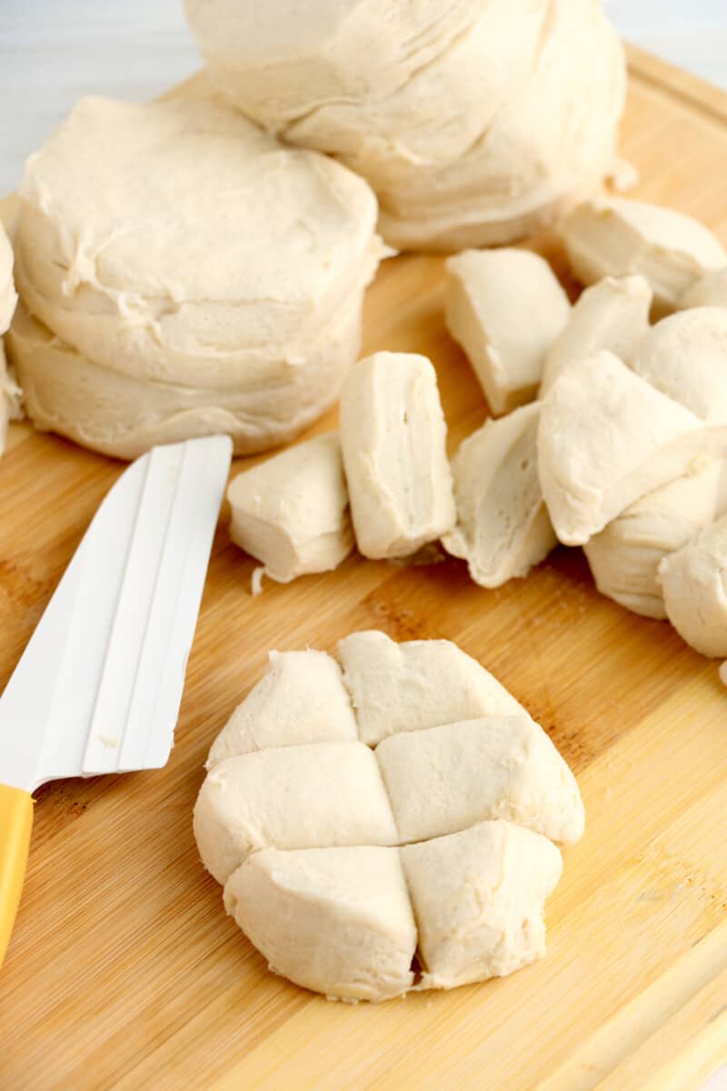 cutting refrigerated biscuit dough into pieces