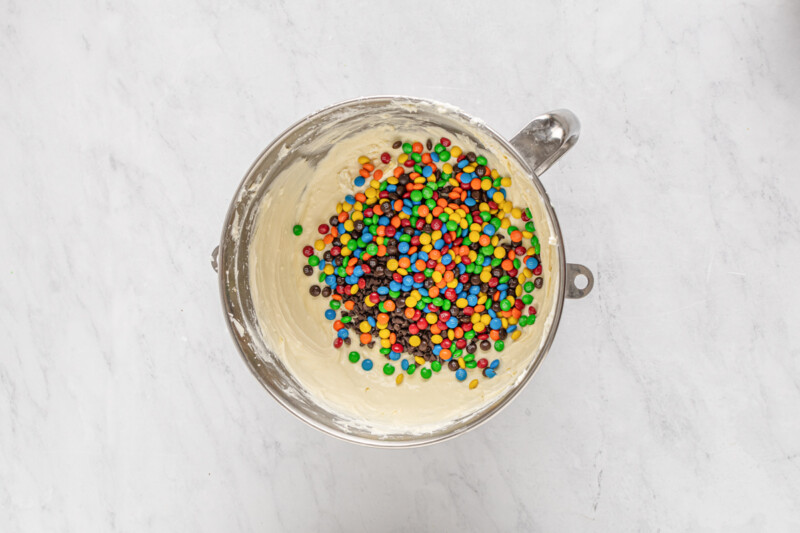 a metal bowl filled with m&m's and sprinkles.