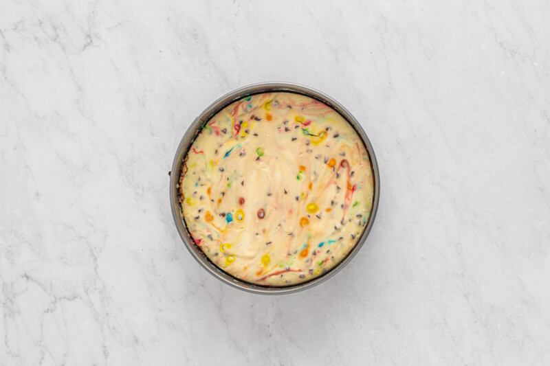 a cake with sprinkles on top of a marble countertop.