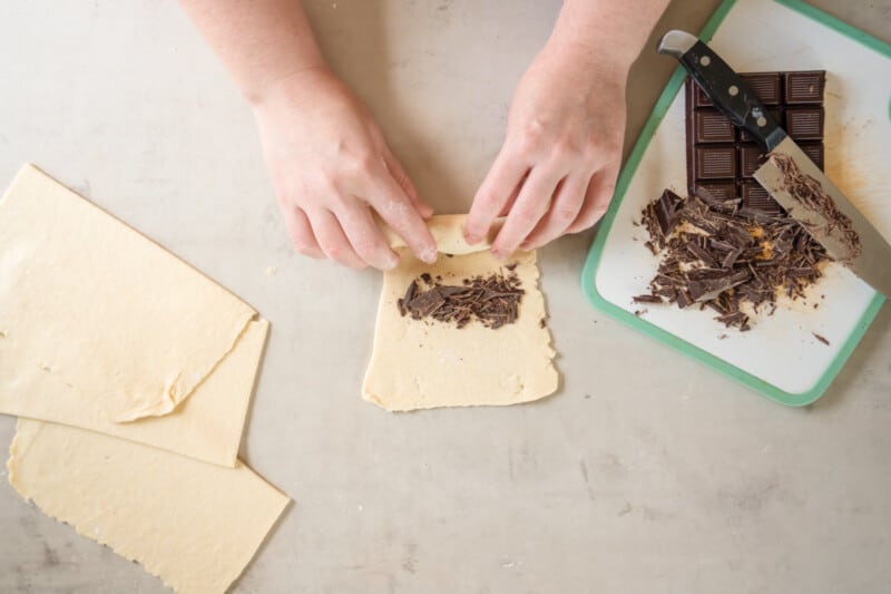 rolling up chocolate shards in the croissant dough