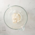 whipped cream in a glass bowl on a white background.