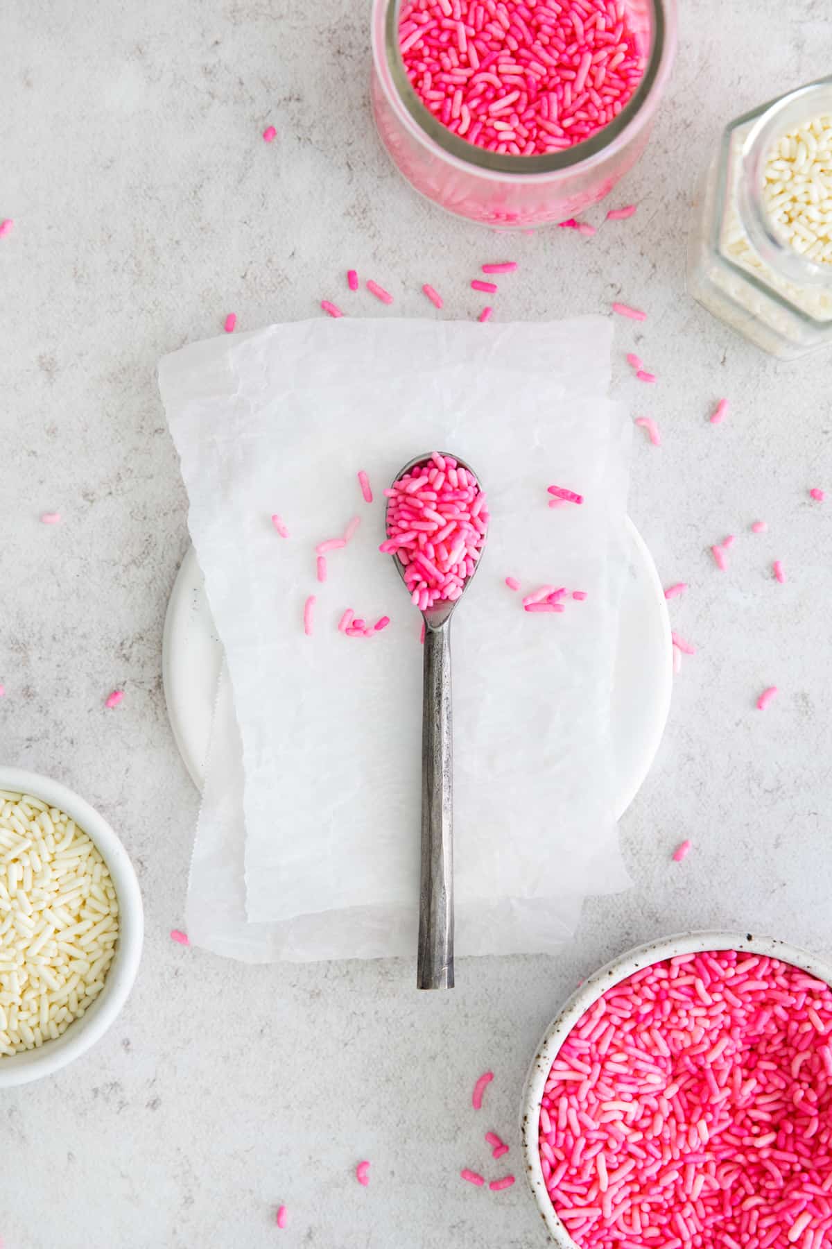 pink dyed sprinkles on a spoon