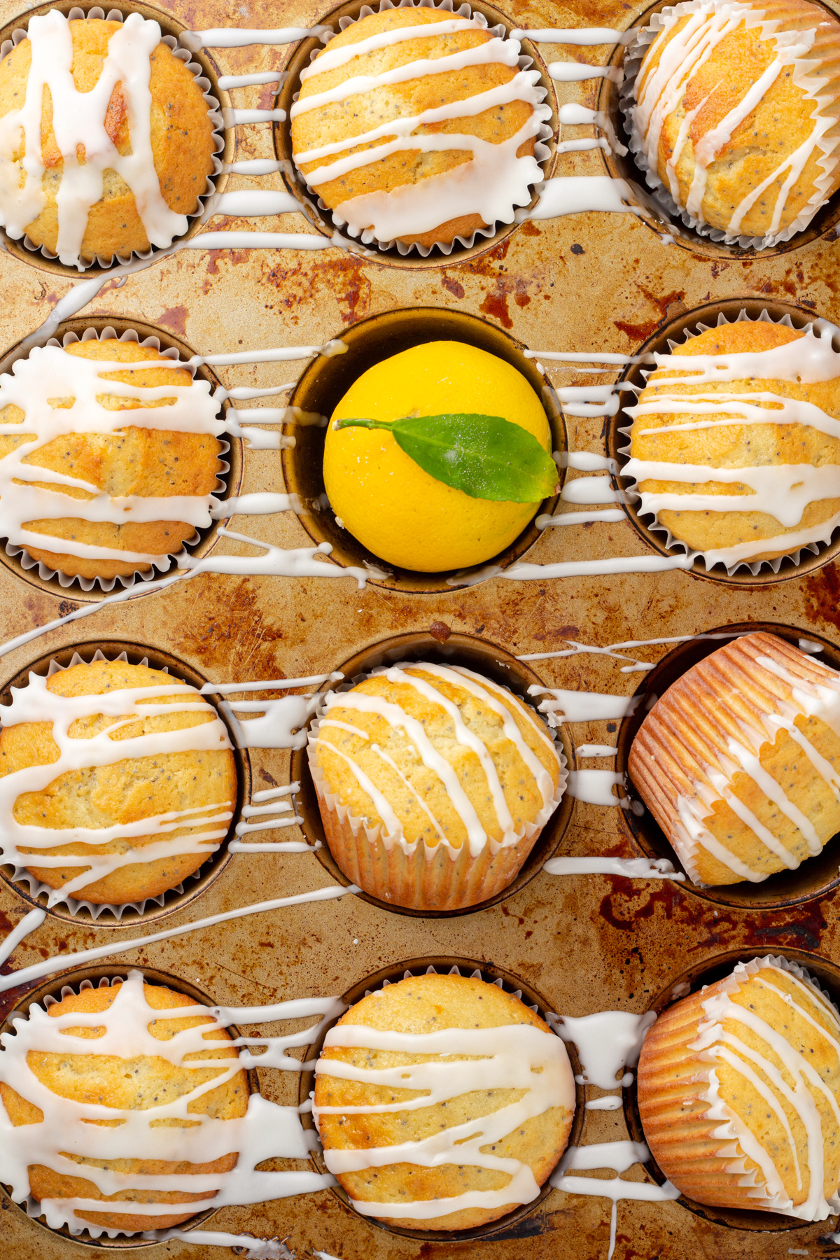 close up overhead view of a muffin tin full of lemon poppy seed muffins
