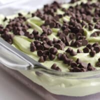 close up mint chocolate chip brownies in a glass pan