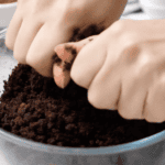 crumbling chocolate cake scraps in a glass bowl.