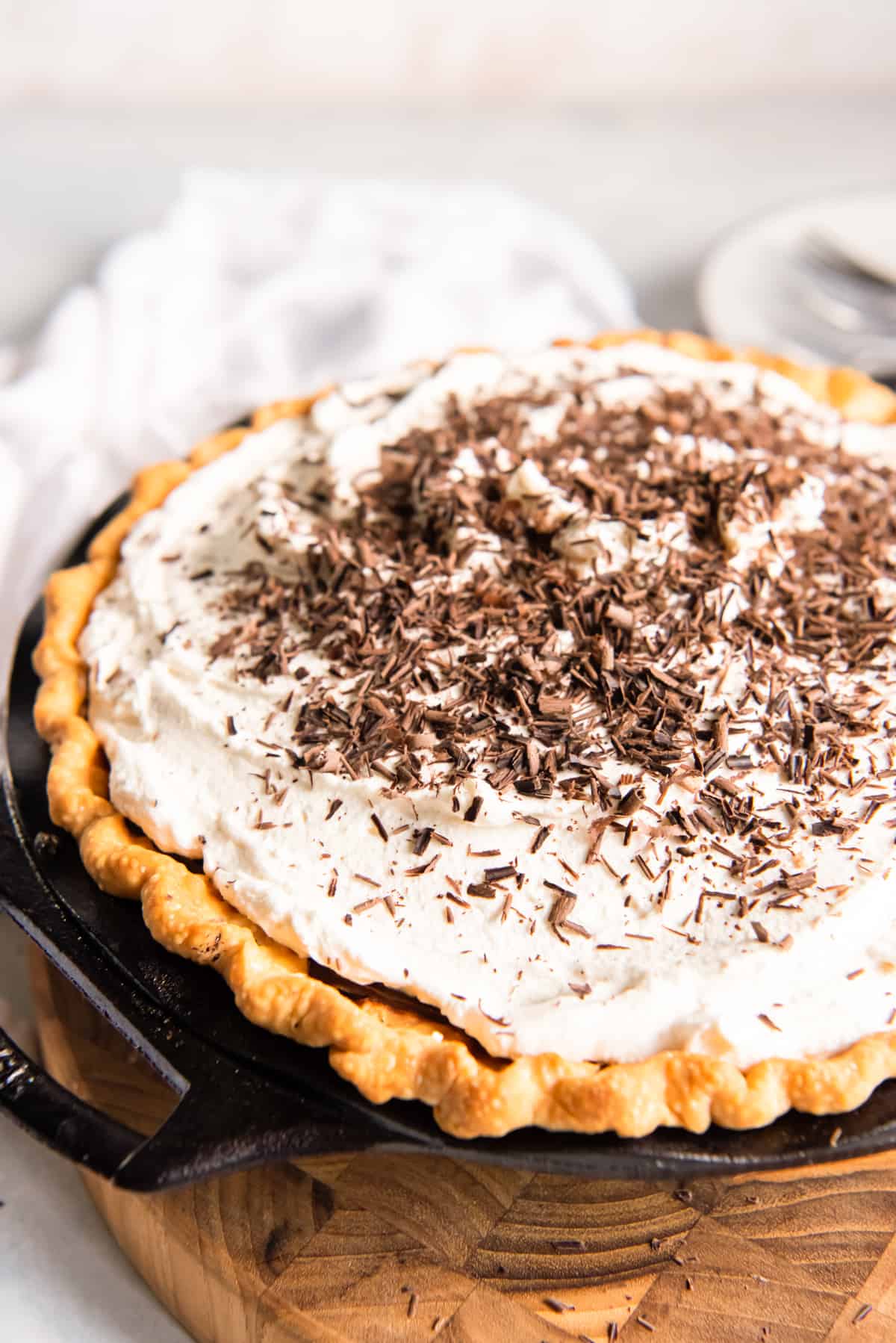 chocolate cream pie with whipped topping and chocolate shavings