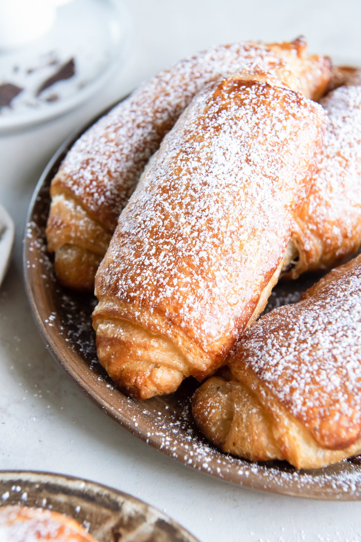 a tray of pain au chocolate, coated with powdered sugar