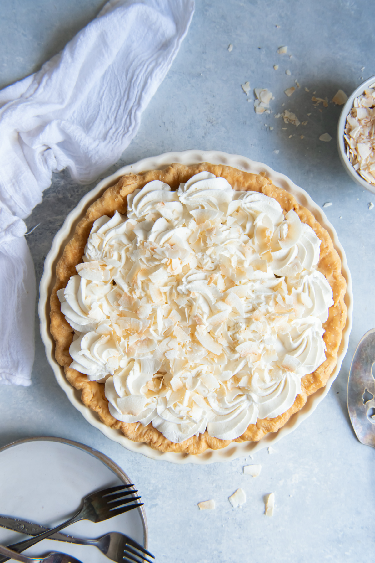 overhead view of a whole coconut cream pie with whipped topping