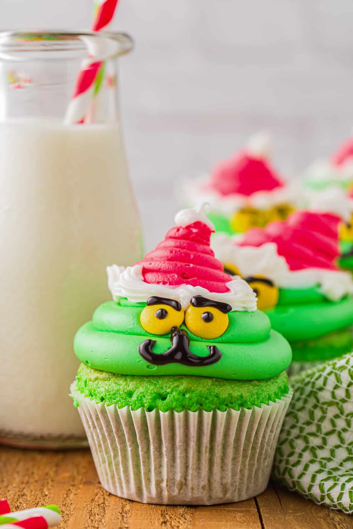 close up on a cupcake decorated to look like the grinch
