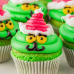 a plate of grinch cupcakes