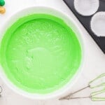 a bowl of green cupcake batter