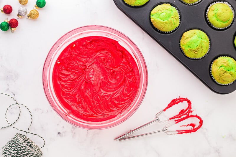 a bowl of red dyed frosting
