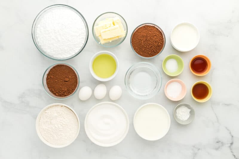 overhead view of ingredients for chocolate fudge cake in individual bowls.