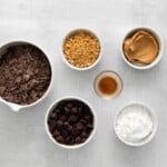 The ingredients for chocolate peanut butter ice cream in bowls on a white background.