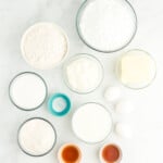 overhead view of ingredients for doctored white cake mix in individual bowls.