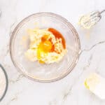 wet ingredients for heart thumbprint cookies in a glass bowl.