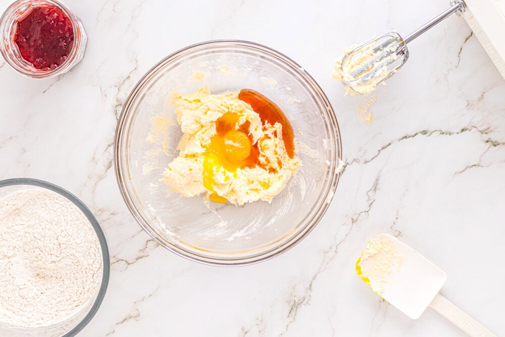 wet ingredients for heart thumbprint cookies in a glass bowl.