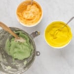 3 bowls of colored sherbet cupcake frosting.