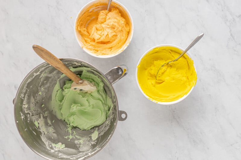 3 bowls of colored sherbet cupcake frosting.