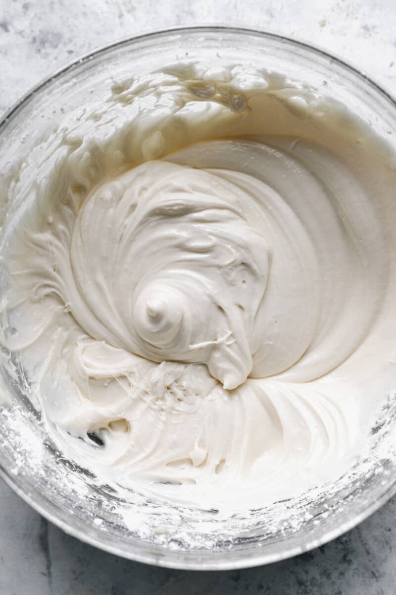 cream cheese frosting for banana cake in a glass bowl.