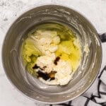 butter, sugar, eggs, and vanilla in a stainless mixing bowl.