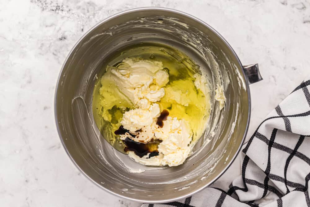 butter, sugar, eggs, and vanilla in a stainless mixing bowl.