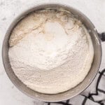 dry ingredients for naked cake added to wet in a stainless mixing bowl.