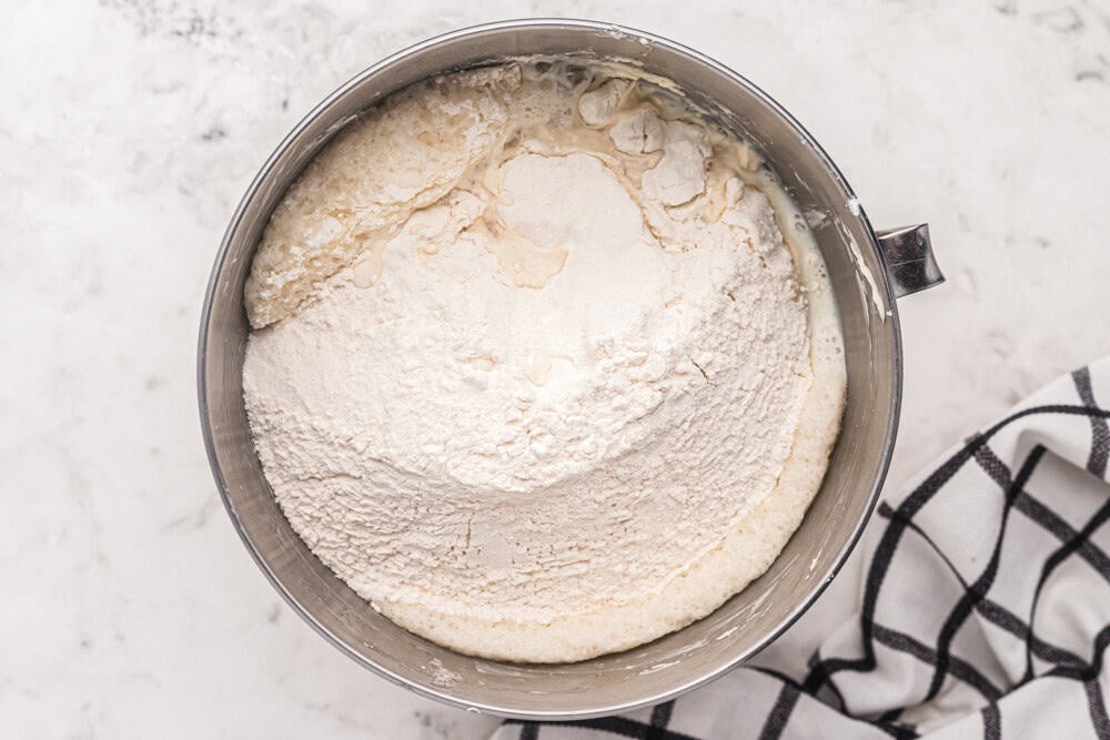 dry ingredients for naked cake added to wet in a stainless mixing bowl.