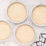 naked cake batter in 4 round cake pans.