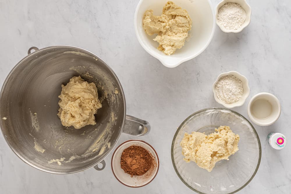 a bowl of flour, eggs, sugar, and other ingredients.