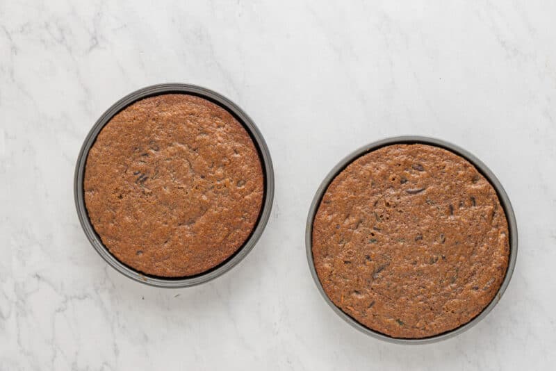 two round cake pans on a marble surface.