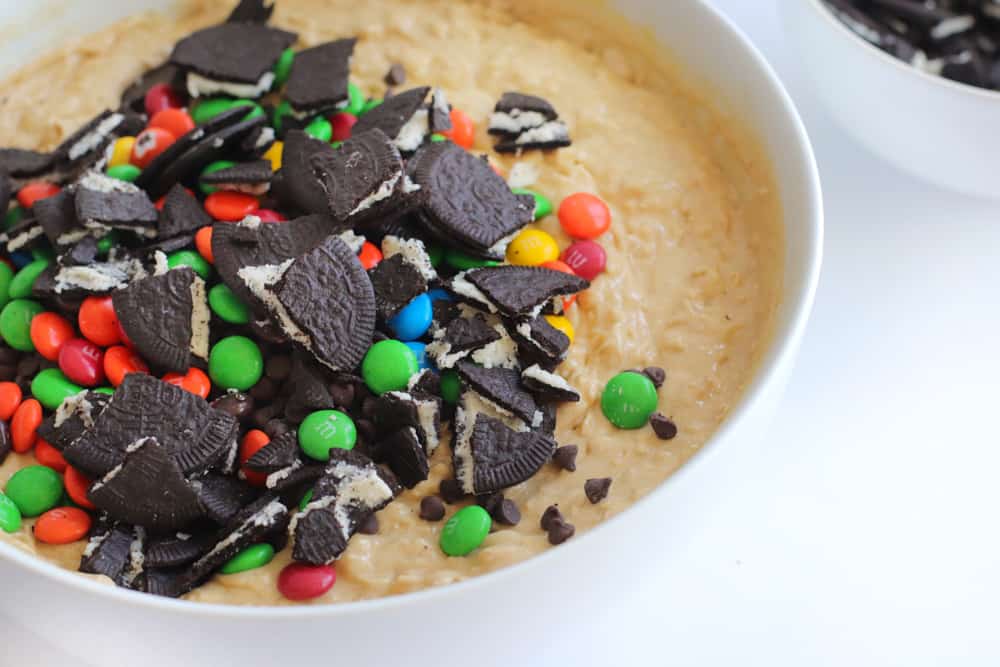 crumbled Oreos and M&Ms piled on top of cookie dough