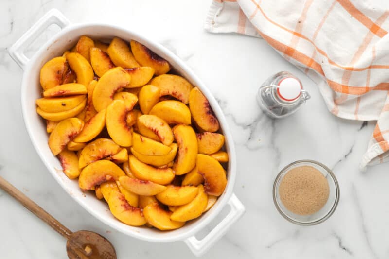 baking dish filled with peach slices