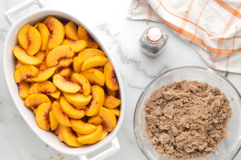 a bowl of peaches and a bowl of brown food.