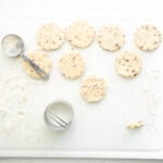 a white board with round cookies and a cookie cutter.