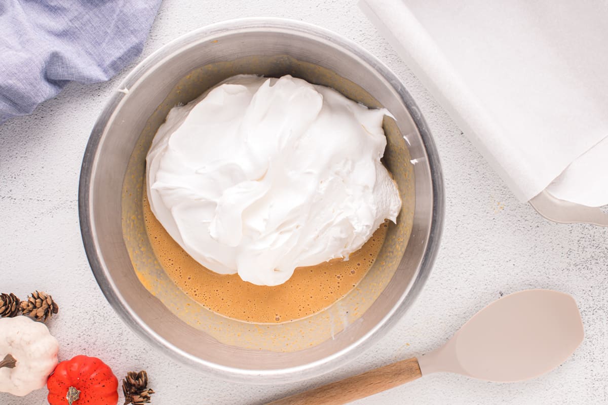 a bowl of cream in a bowl with a spoon.