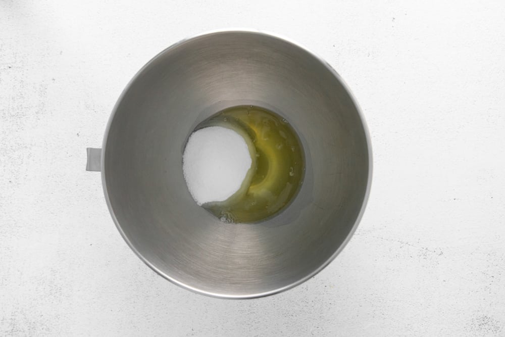 sugar and egg whites in a stainless mixing bowl.