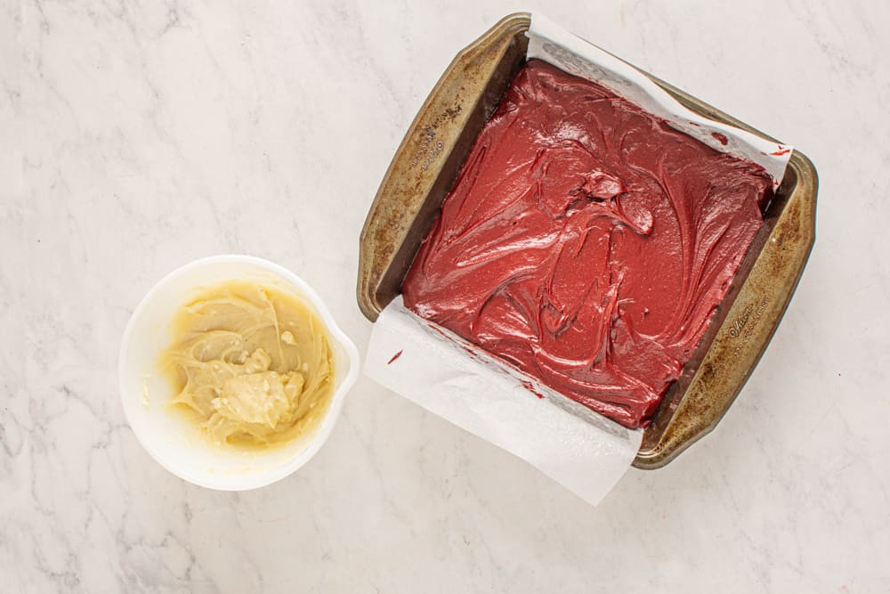 red velvet brownie batter in a square baking pan.