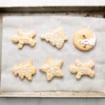 iced christmas cookies on a baking sheet.
