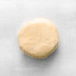 a round white dough wrapped in plastic.