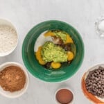 wet ingredients for avocado brownies in a green bowl.