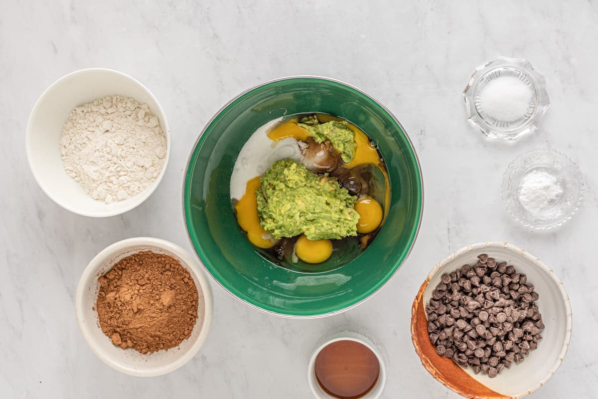 wet ingredients for avocado brownies in a green bowl.